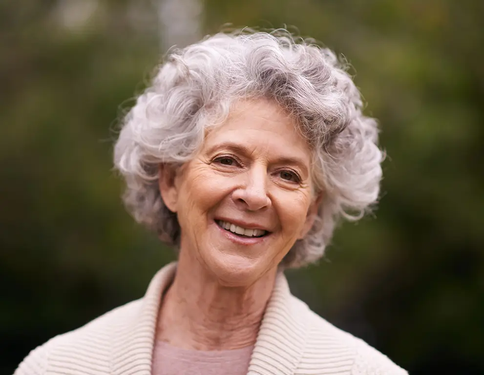 A patient smiling after dental implant treatment