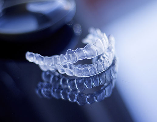 A set of clear Invisalign aligners