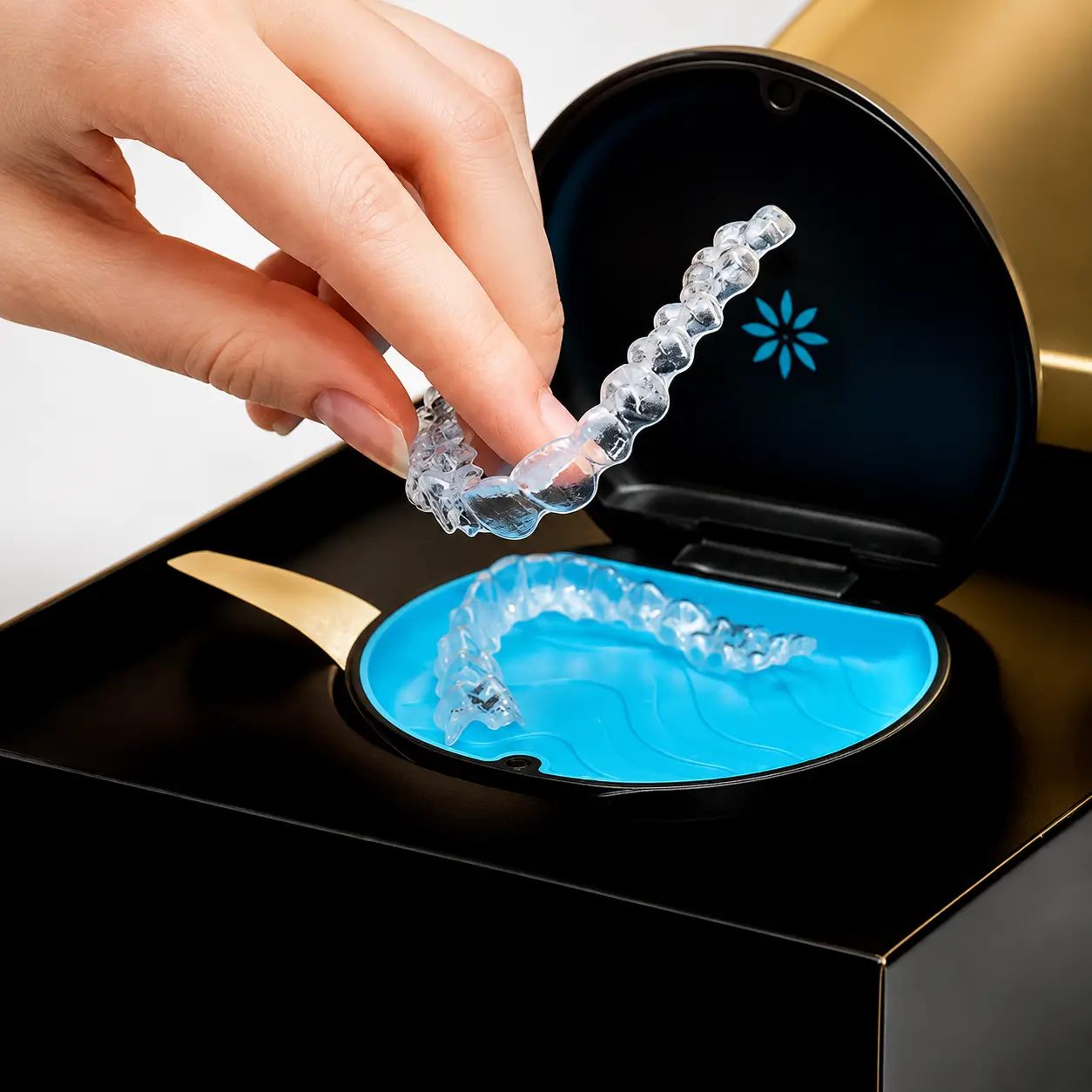 A patient holding an Invisalign clear aligner