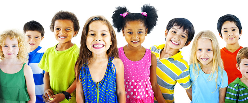 A group of children of various ages and ethnicities smiling at the camera against a plain background